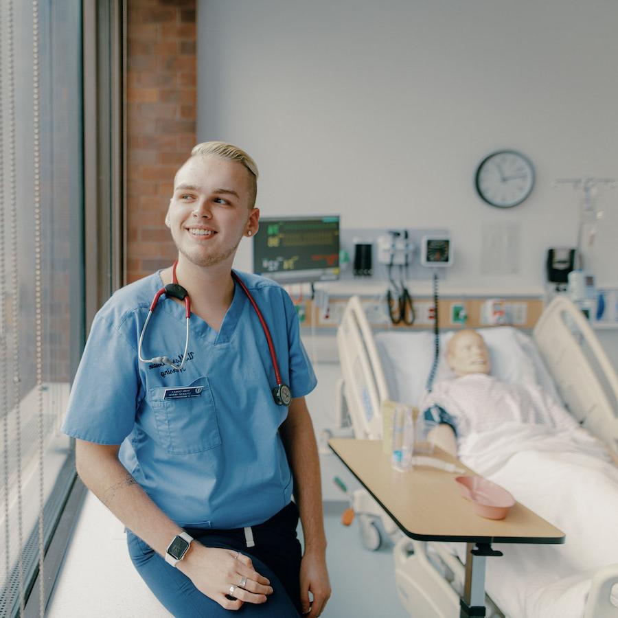 Male nursing student in nursing lab and uniform
